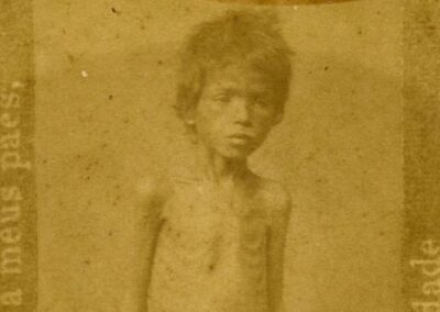 Uma criança, visivelmente debilitada pela fome e pela sede, representa o sofrimento humano causado pela Grande Seca do Nordeste. Milhares de crianças foram as maiores vítimas dessa tragédia, sucumbindo a doenças e à desnutrição.