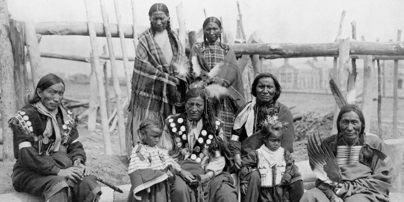 Uma família Sioux em seu ambiente tradicional, retratando a vida cotidiana e a transmissão de costumes e valores entre gerações. A imagem oferece um vislumbre da estrutura familiar e do papel de cada membro na manutenção da cultura e da identidade Sioux. Fonte: Lakota Mall.